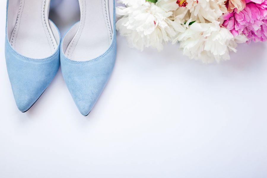 Light-blue-suade-wedding-shoes-next-to-flower-beauquet