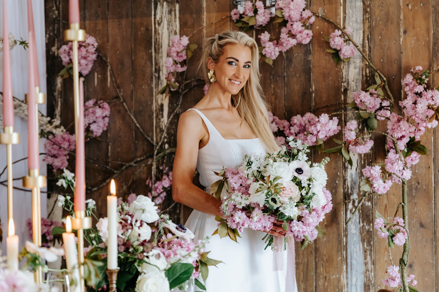 Bride in front of blossom decorated doors